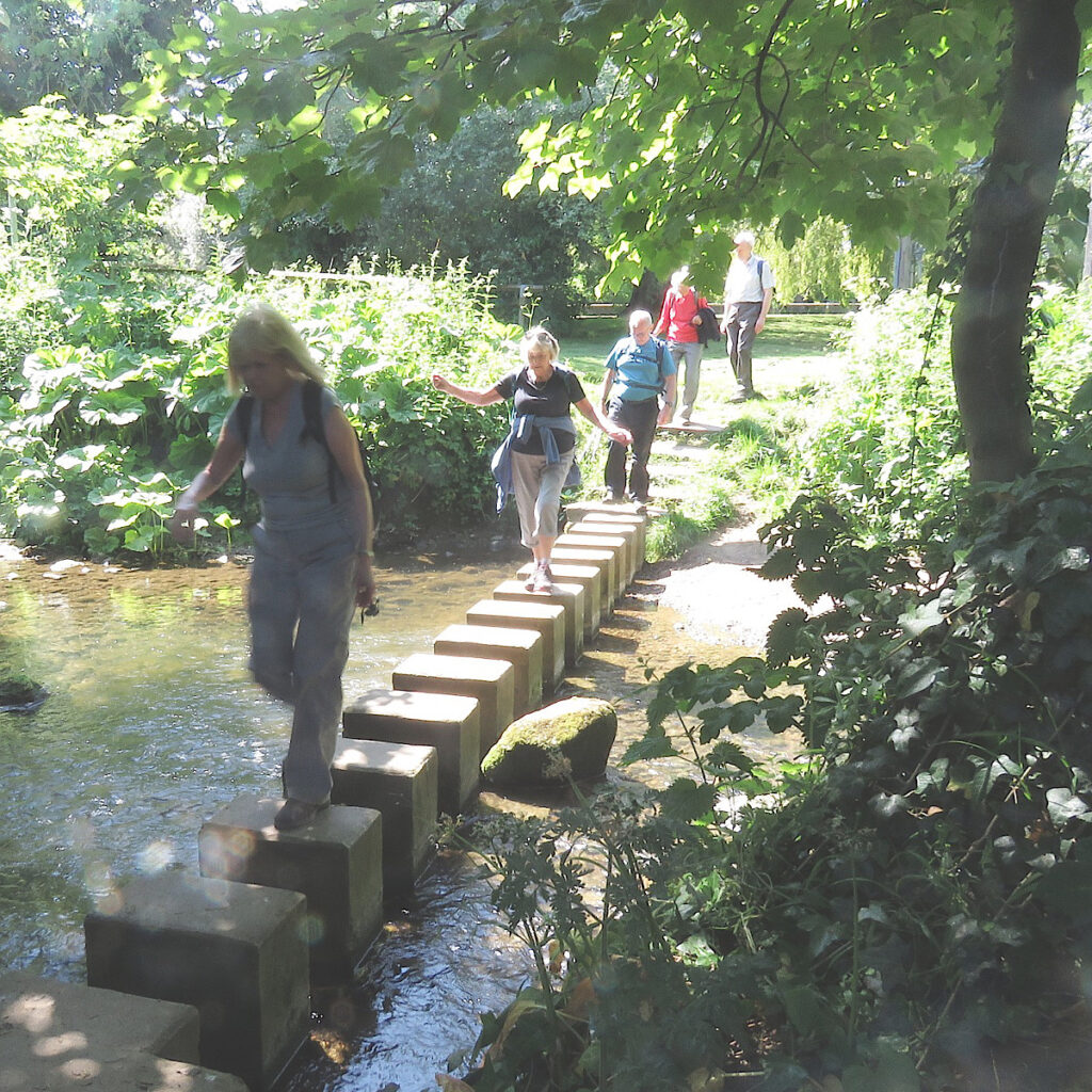 walking group crossing stream