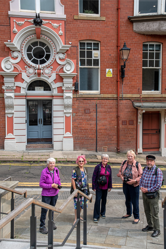 Group of members standing outside a building in Newcastle
